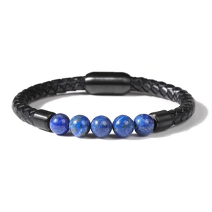Macro view of blue tiger eye stone beads on a black braided leather bracelet with magnetic clasp