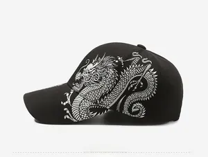 Detail of silver dragon embroidery on a black cotton baseball cap side view