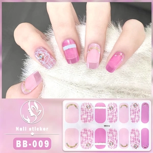 Detailed view of pink 5D gel nail stickers with plaid patterns and metallic chain accents