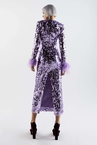 Detail view of purple sequin dress featuring feathered cuffs and elegant back slit design