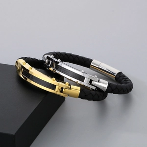 Detail of men's braided leather bracelets with carbon fiber inlay and metallic clasp