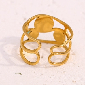 Detail view of gold wave layered ring with turquoise inlay on white stone surface