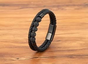 Macro view of double-layer braided leather bracelet with natural lava stones and magnetic clasp