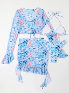 Detail view of four-piece floral swimsuit with long-sleeve top and drawstring skirt