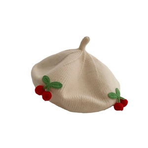 Cream knit baby beret hat with 3D cherry accents and soft textured finish for winter