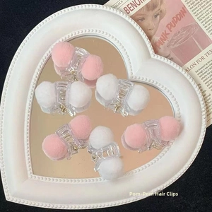Set of 6 mini acrylic hair clips with soft pink and white faux fur pom poms on a tray