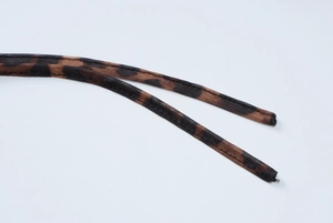 Close-up of brown leopard print mesh fabric with detailed ties and stitching
