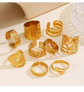 Macro detail of nine 18K gold plated leaf and geometric rings in bohemian style