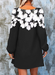 Back view of a long-sleeved floral print dress with white tulip patterns on black fabric