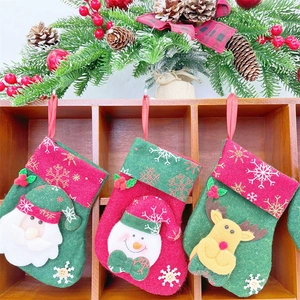 Detailed view of felt Christmas stockings with Santa, snowman and reindeer hangings