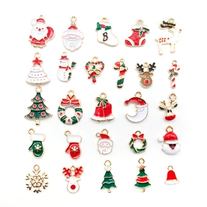Macro shot of assorted Christmas enamel charms including Santa, elk, and bells