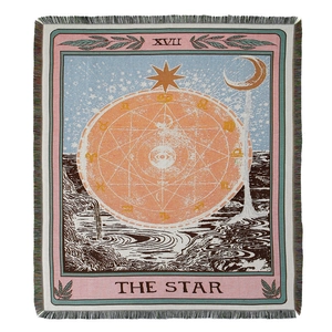 Macro detail of the woven texture and fringes on The Star Tarot bohemian blanket