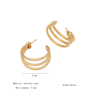 Close-up of golden multi-loop C-shape stainless steel earrings with 2.5cm diameter