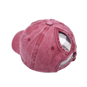 Detail van bordeauxrode baseballpet van gewassen katoen met opening voor hoge paardenstaart