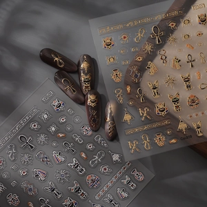 Ancient Egyptian gold and silver nail art stickers featuring Eye of Horus and Bastet icons