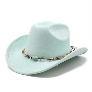 Detail of mint green suede cowboy hat with bohemian shell and turquoise bead band