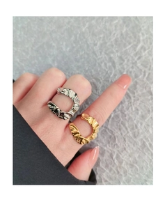 Close-up of gold and silver irregular pleated rings showing metallic crinkle texture