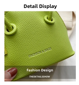 Detail of lime green litchi texture leather bag with silver FASHION & BAGS lettering