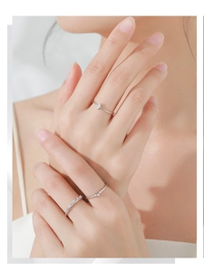 Detail of S925 silver crown geometric rings set with cubic zirconia on female hand