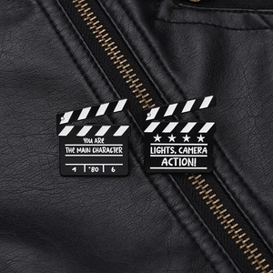 Detail of film slate pins with text on black leather background for a cinematic look