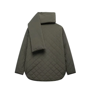 Detail of olive green quilted jacket with matching scarf and diamond pattern