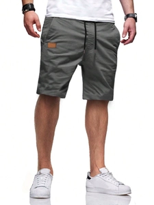 Detail of men's dark grey casual shorts with black and white drawstring and leather patch