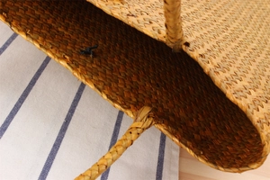 Detailed top view showing the interior structure and texture of a woven straw beach bag
