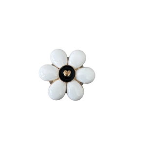 Floral phone socket with white petals and gold heart center on a white background