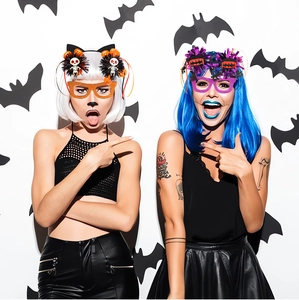 Detail of Halloween costume headbands and glitter glasses worn by models in party setting