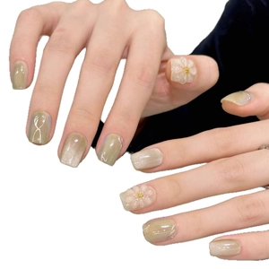Short square press-on nails with champagne cat-eye base and 3D floral accents