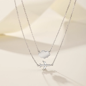 Detail of S925 silver necklace featuring elegant cloud and airplane travel pendants