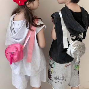 Kids round crossbody bag in pink and silver colors with woven tassel and wide shoulder strap