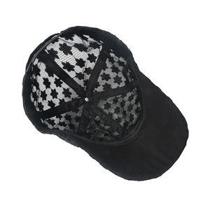 Internal view of black lace baseball cap showing floral mesh pattern and inner seam details