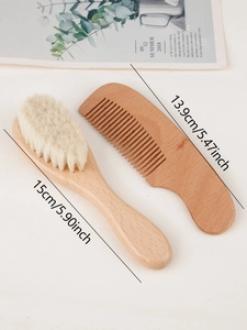 Top view of wooden baby hairbrush and comb set with dimensions on a textured background