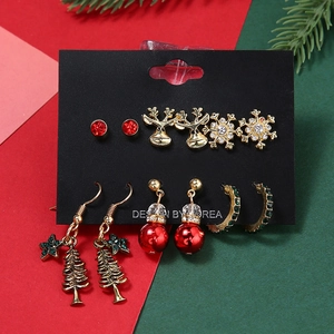 Close-up of a 6-pair Christmas earring set with reindeer, snowflake and tree designs