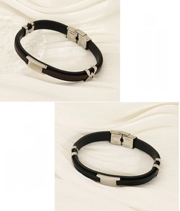 Detail showing dual-layer leather bracelets with polished stainless steel magnetic clasps