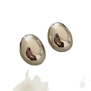 Minimalist silver oval bean stud earrings with high-gloss metallic finish on white background