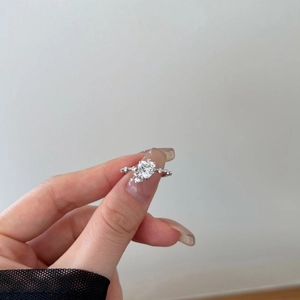 Close-up of S925 sterling silver ring featuring a heart-shaped zircon and side stones