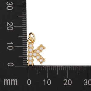 Detailed measurement of gold letter K pendant with pearls, sized 12mm x 15mm on a ruler