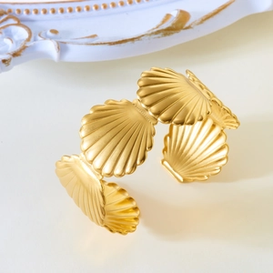 Macro detail of golden scallop shell patterns on the vintage stainless steel bangle