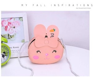 Close-up of pink PU bunny crossbody bag with cute 3D ears and bow tie for girls