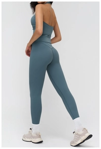 Detail of greyish-blue yoga set featuring hollow back sports bra and high-waist leggings