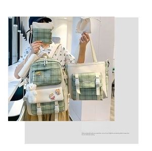 Detailed set of green plaid canvas school bags with bear pendants and stylish badges