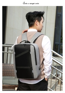 Business laptop backpack with grey fabric and black leather panels shown on a model