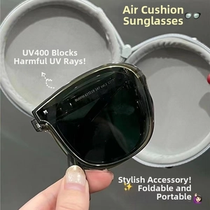 Detail view of foldable sunglasses with gray lenses and matching round zipper storage case