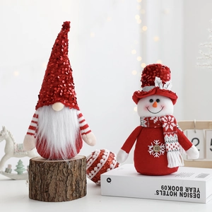 Close-up of plush Christmas gnome and snowman dolls with sequins and knit details
