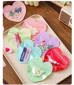 Macro detail of heart-shaped zip-lock bags in macaron colors for jewelry and candy