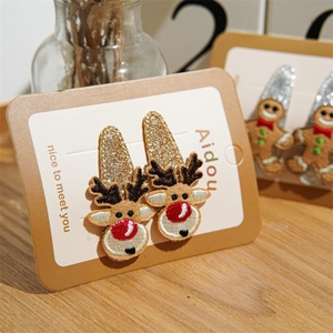 Cute Christmas hair clips set with embroidered reindeer and gingerbread man on card
