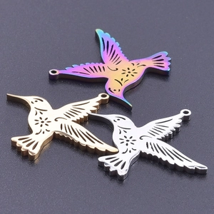 Detailed view of hummingbird charms in gold, silver, and rainbow colors for DIY jewelry