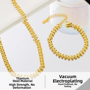 Detailed macro of gold titanium steel star-link necklace and bracelet set with vacuum plating